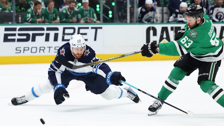 Winnipeg Jets center Gabriel Vilardi (13) blocks a shot by Dallas Stars' Evgenii Dadonov 
