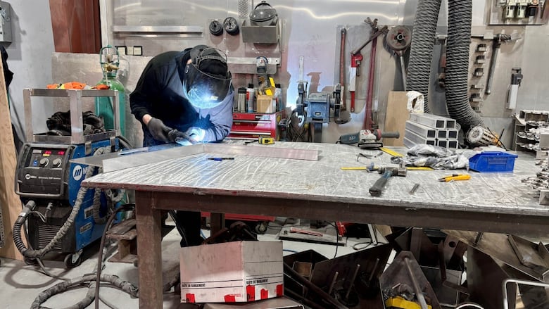 Someone welding two pieces of metal together