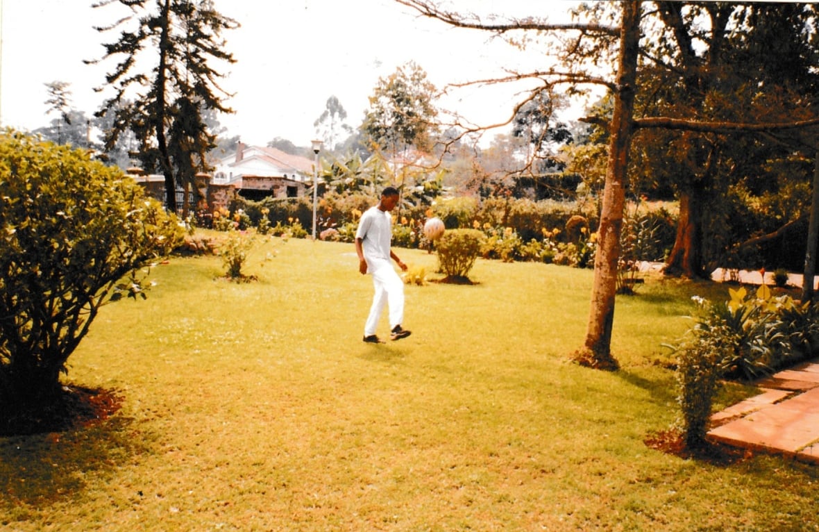 A young man kicks a soccer ball.