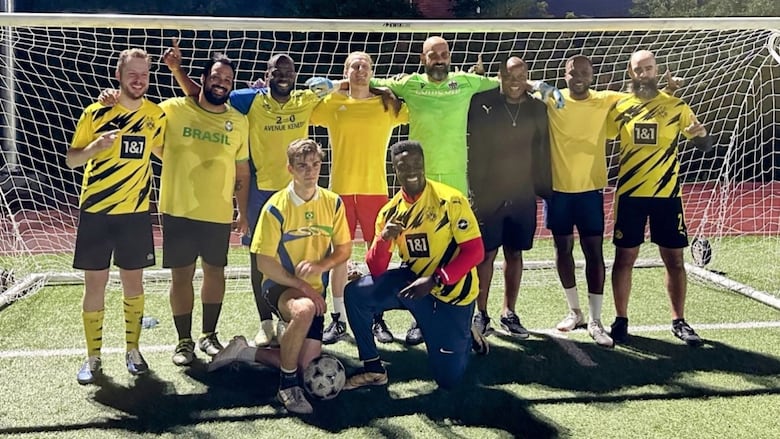 An old photo of a soccer team wearing yellow jerseys.