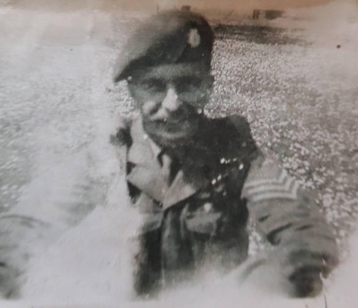 A black and white photo of Gordon Patrick.  He's smiling, sporting a mustache, and wearing a military uniform.