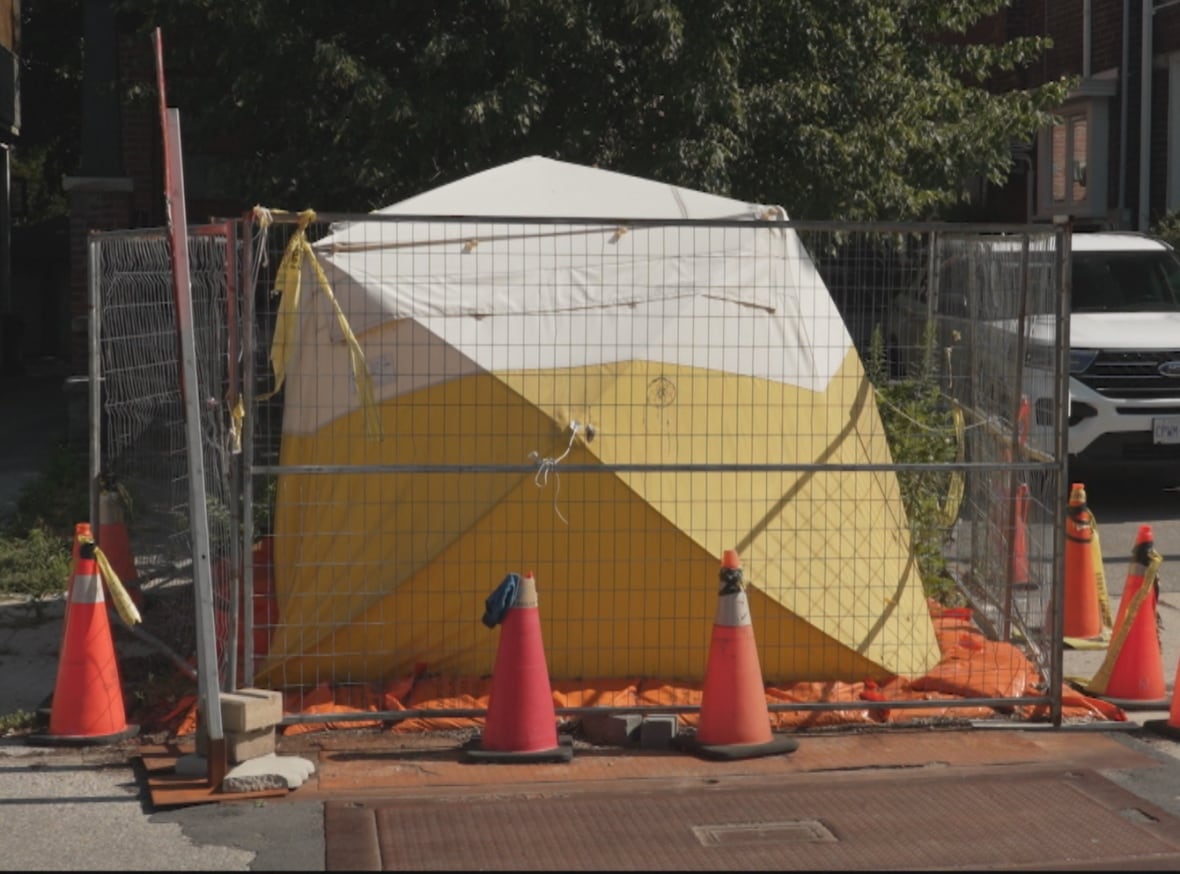 A view of the site on Withrow Avenue. There is a tent, fencing and security at the site.