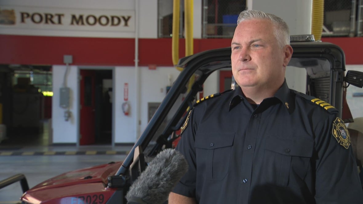 A man wearing a firefighter's uniform is seen in a fire hall.