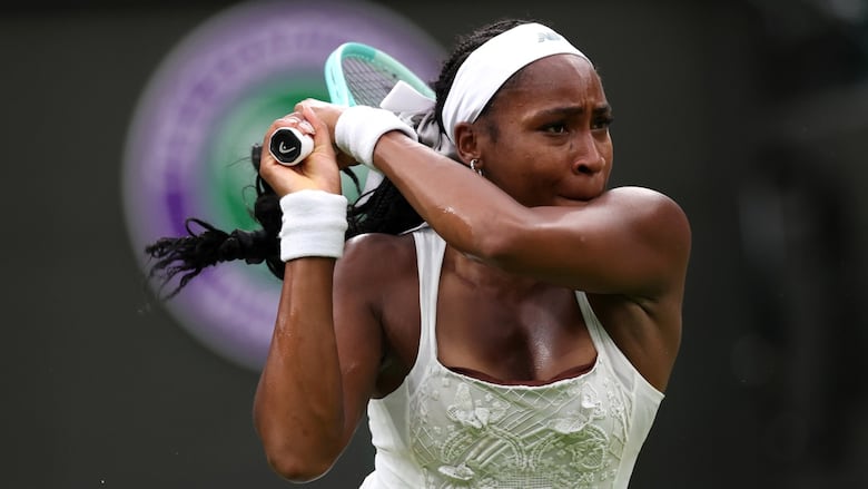 A tennis player hits the ball.