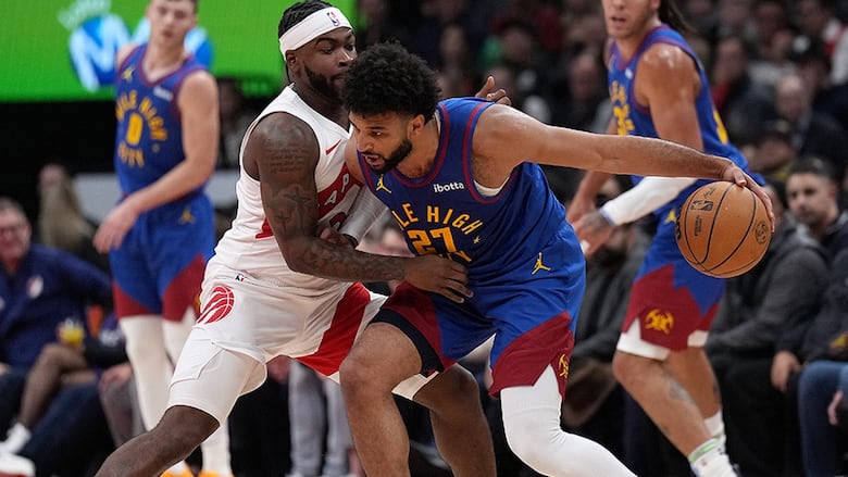 Canadian basketball player Jamal Murray of the Denver Nuggets drives into Toronto Raptors guard Jamal Shead during an NBA regular-season game on October 28, 2024 in Toronto. 