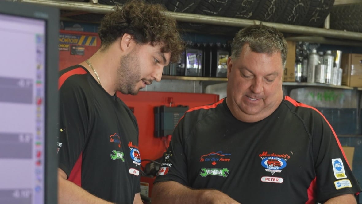 Macdonald's owner Peter Solly goes over work orders with his son Josh.