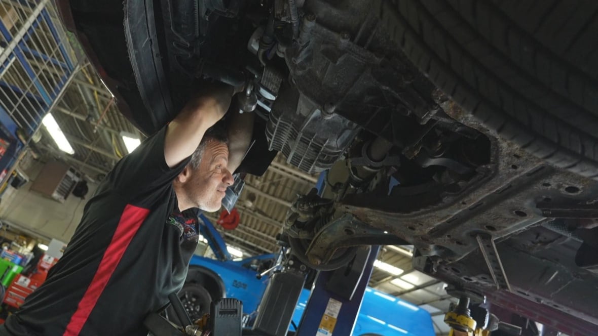 A person working on a vehicle.