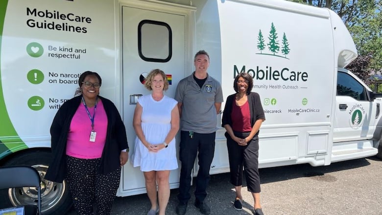 On-site staff members stand outside the MobileCare Clinic in North Buxton.