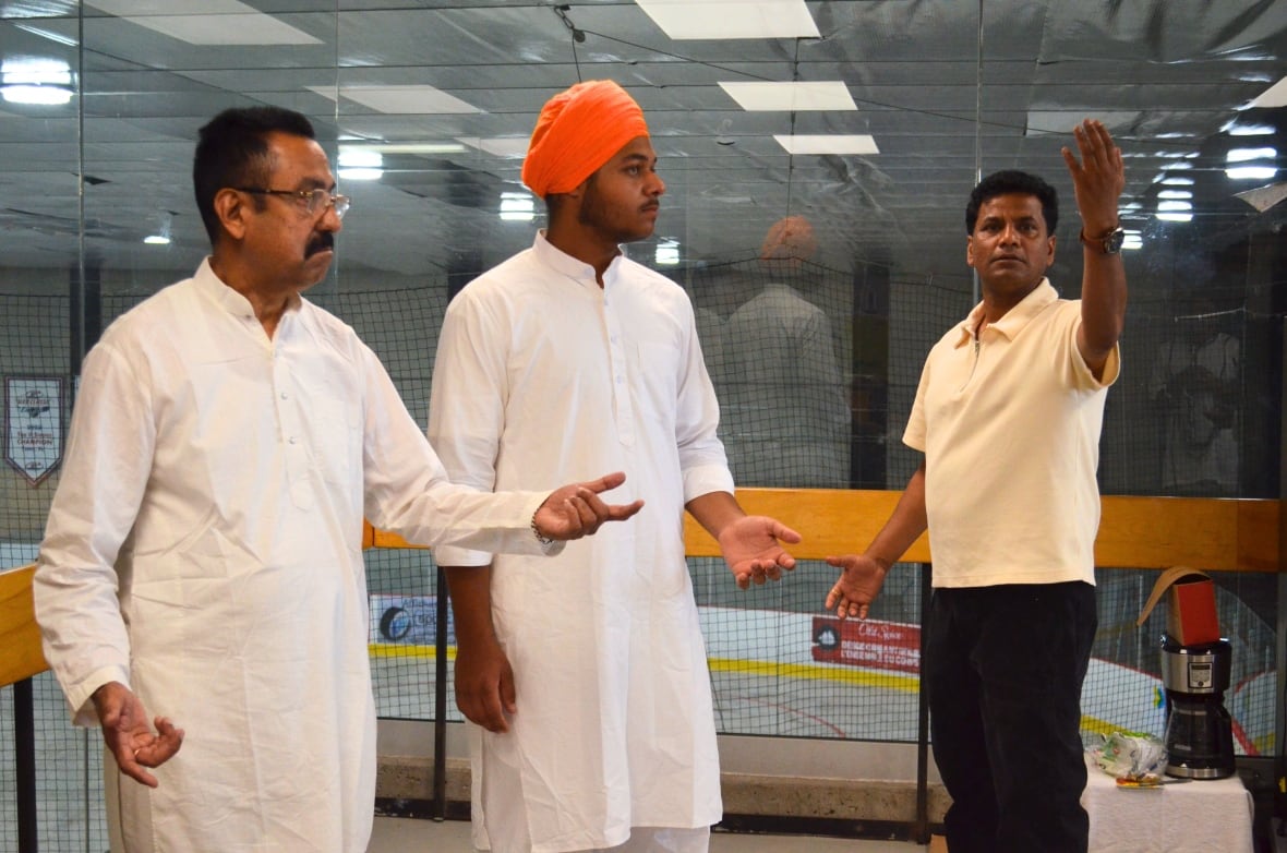 Gaurav Sharma, right, gives stage directions to two actors.
