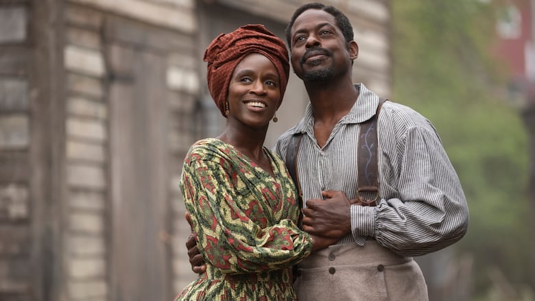 An image of a woman and man holding each other in 19th century clothing.