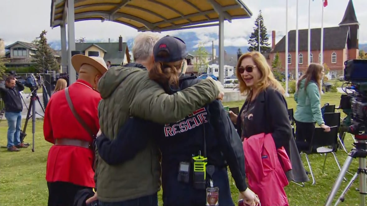 People hugging fire department crew