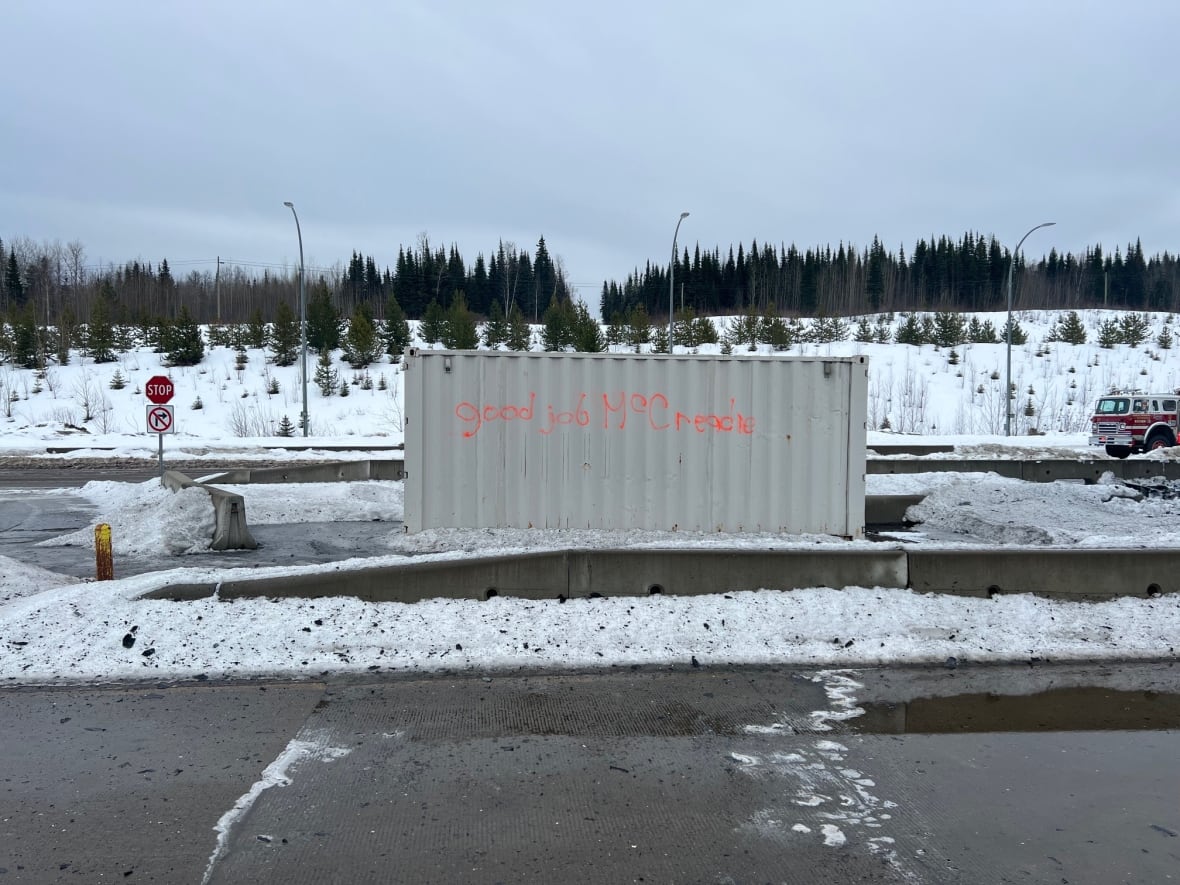 A shipping container painted with crudely written words that say 'good job, McCreadie.