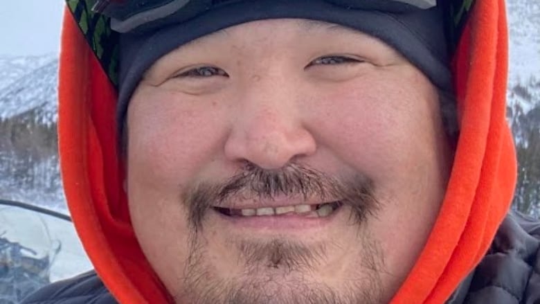 man with ski goggles smiling