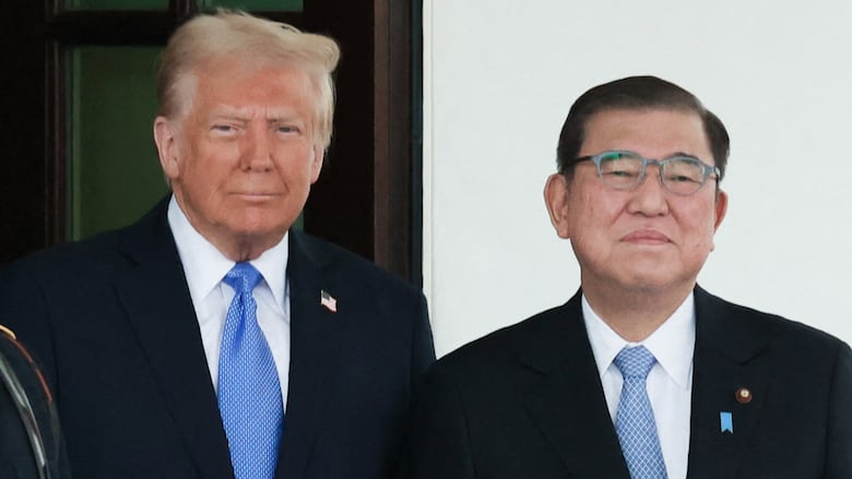 Close up of two men in suits and ties