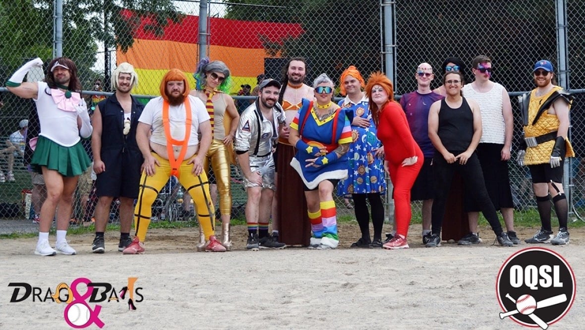A photo of a group of people wearing bright costumes in the style of various superheroes.