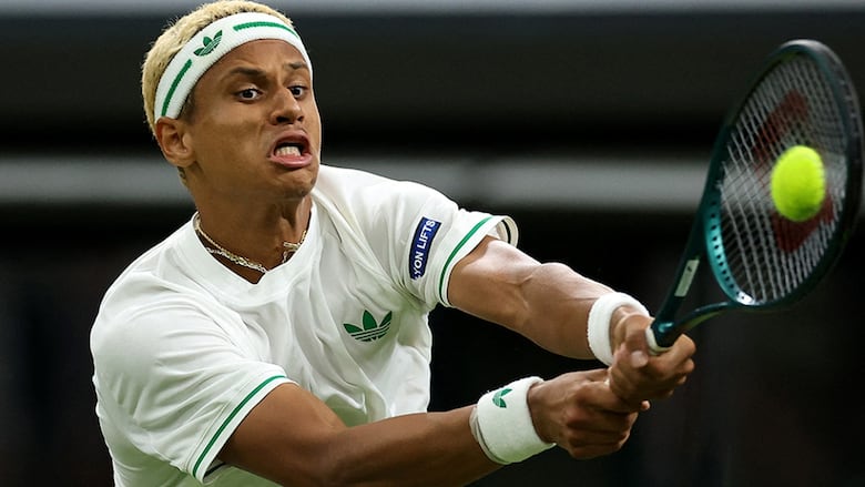 Canadian tennis player Gabriel Diallo returns a shot during second-round play against American Taylor Fritz at Wimbledon on July 2, 2025 in London, England. 