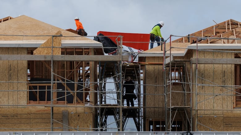 Construction workers use wood and lumber to build residential homes in Irvine, California, U.S., March 28, 2025. 