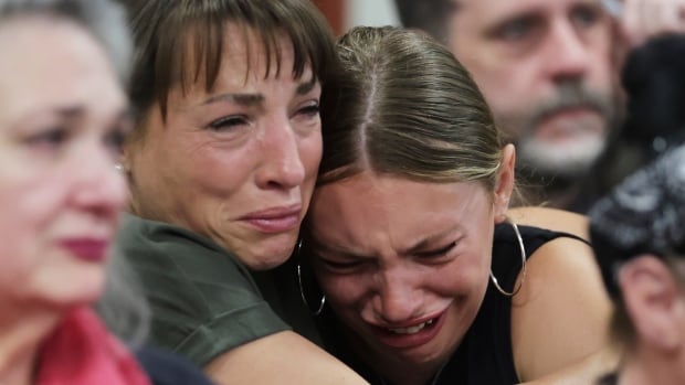 Dylan Mortensen gets a hug after speaking at the sentencing hearing of Bryan Kohberger at the Ada County Courthouse, for his sentencing hearing, Wednesday, July 23, 2025, in Boise, Idaho, for brutally stabbing four University of Idaho students to death nearly three years ago. Close up of two woman embarcing and crying