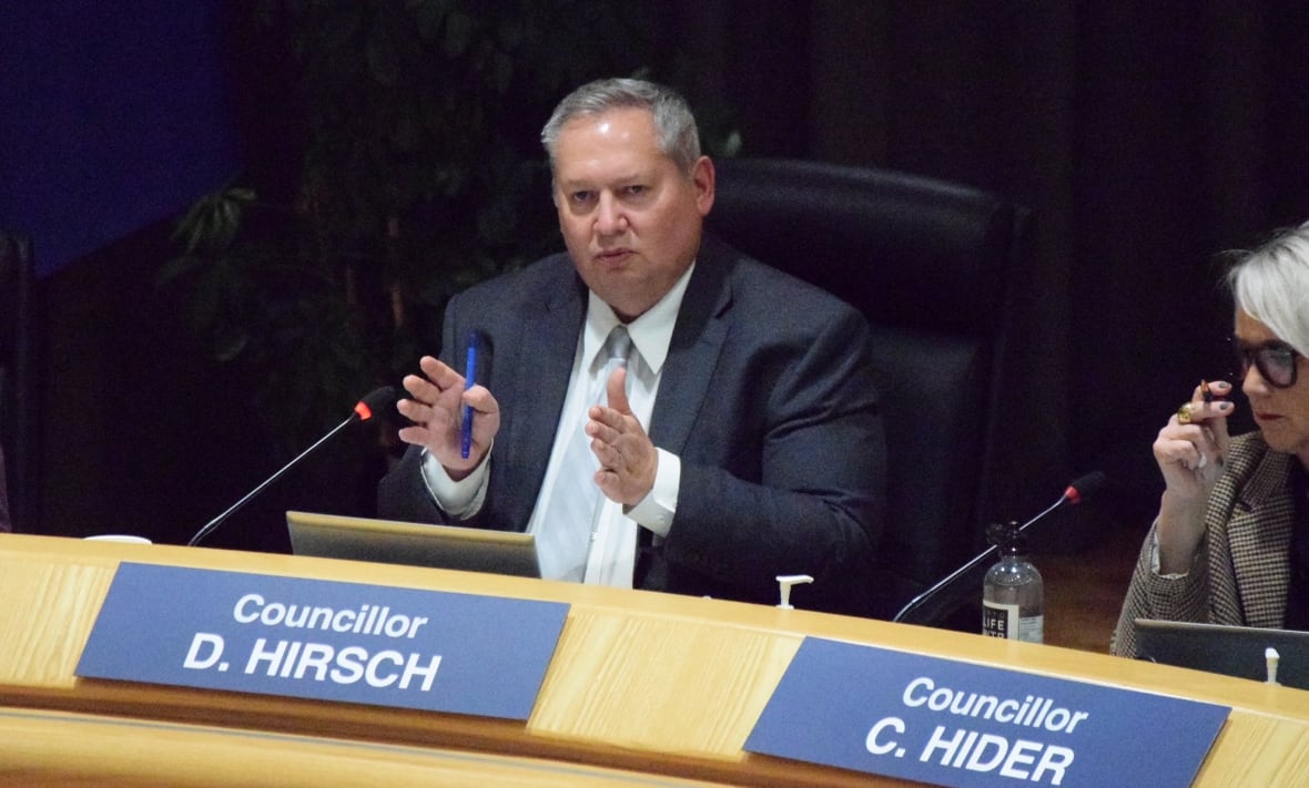 A city councillor makes a point as he speaks during a council meeting.