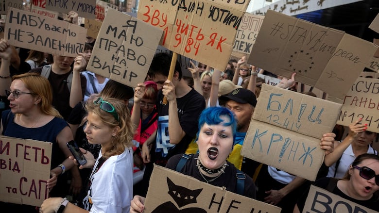 Ukrainians protest against a newly passed law, which curbs independence of anti-corruption institutions, amid Russia's attack on Ukraine, near the presidential office in Kyiv, Ukraine July 23, 2025. 