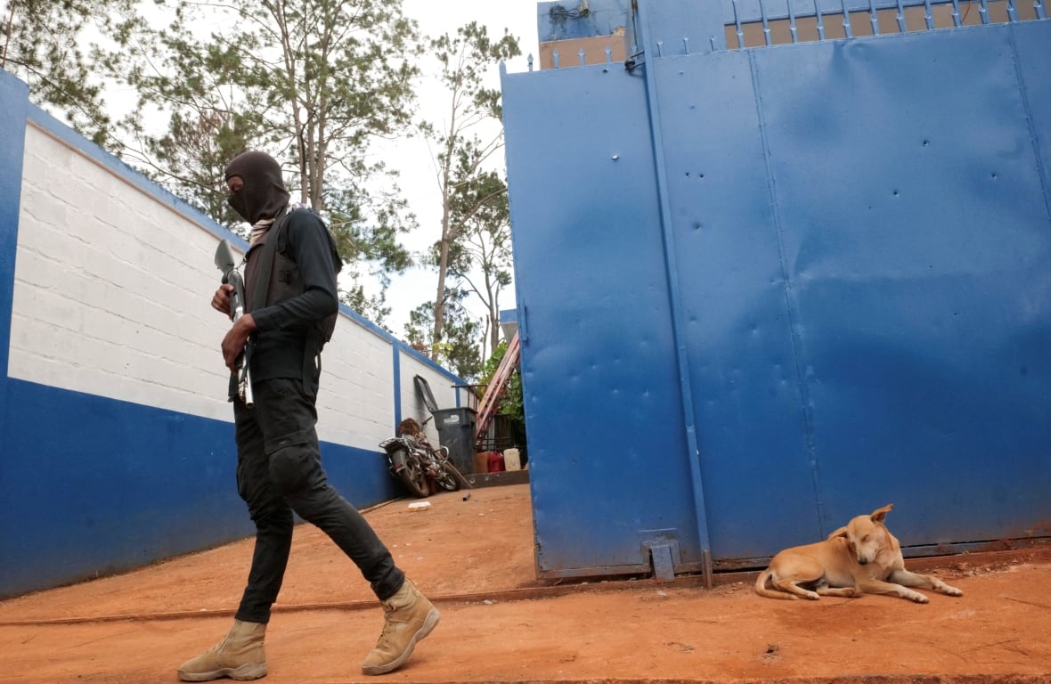 The neighbor's clock member moves outside the Furcy police station in Haiti.