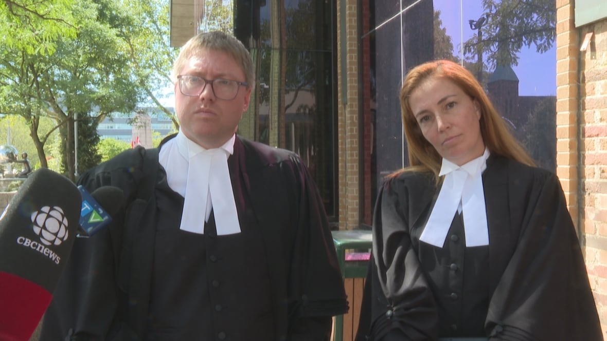Two Crown attorneys in robes.