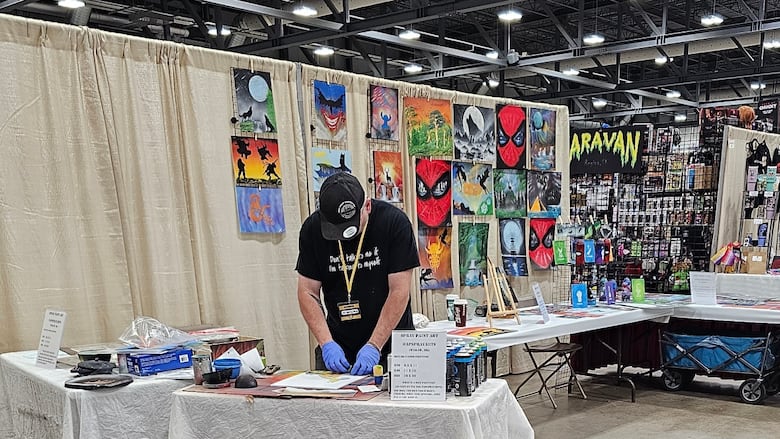 Lorne Oliver, co-owner of AP Spray Art creates an airbrushed artwork.