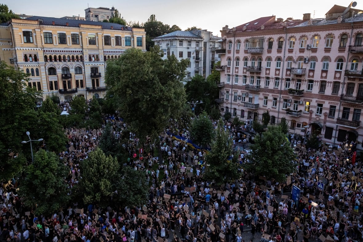 Overhead shot of a city square filled with people holding signs and placards