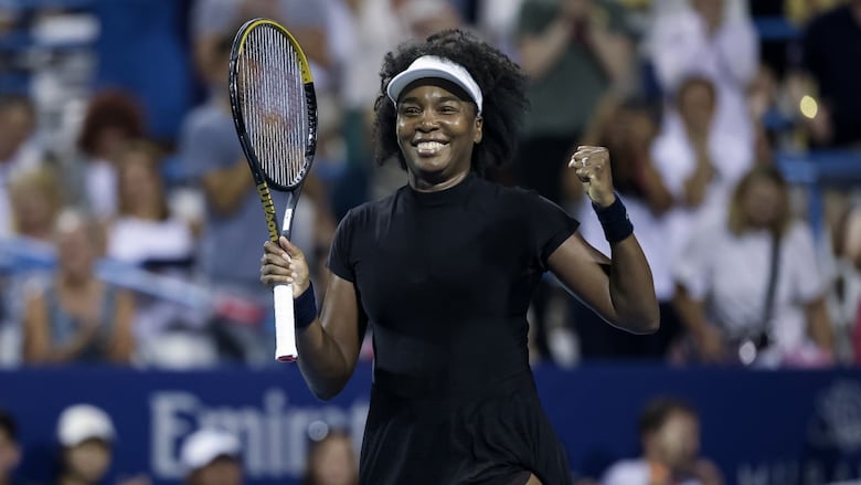 A women's tennis player celebrates.