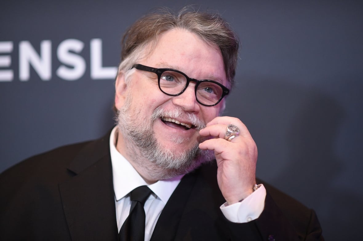 Photo of a man in glasses wearing a suit