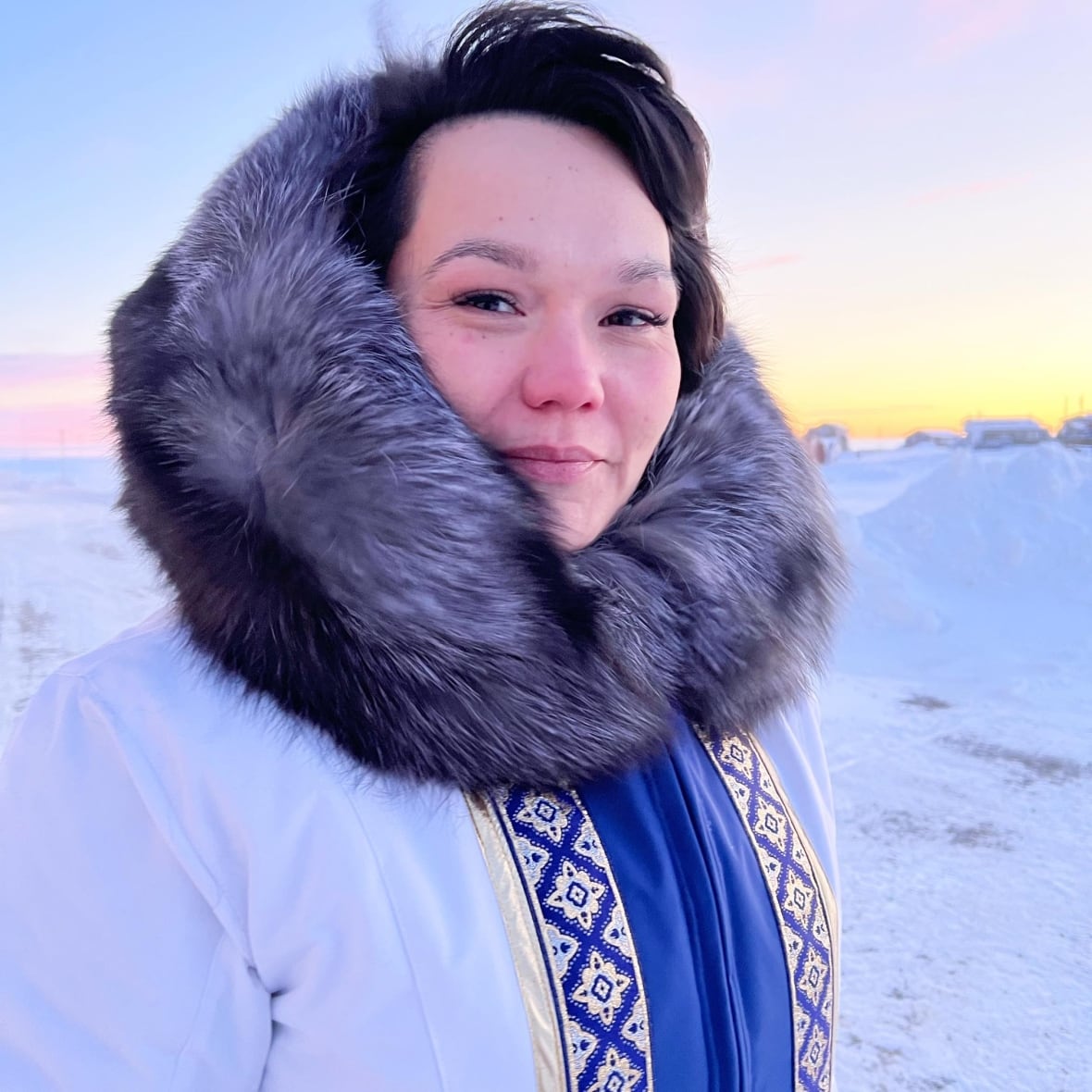 Woman in parka looks at camera