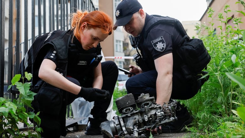 Investigators look at what they say is the engine of a Russian Geran drone after it slammed into an apartment building during a Russian drone strike, amid Russia's attack on Ukraine, in Kyiv, Ukraine June 6, 2025.