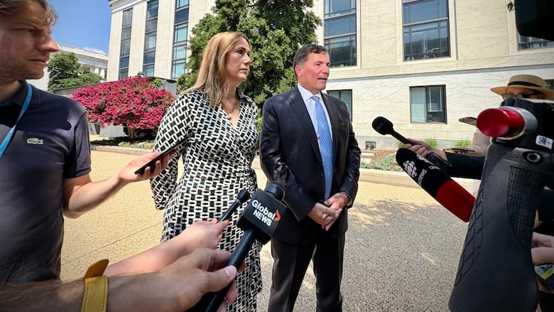Kirsten Hillman and Dominic LeBlanc speak to news media on a summer day 