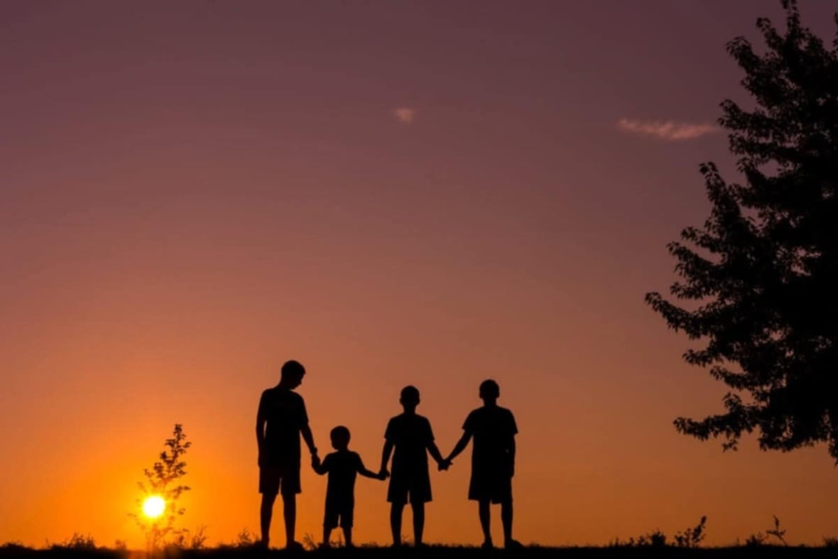 Silhouette of four children with sunset