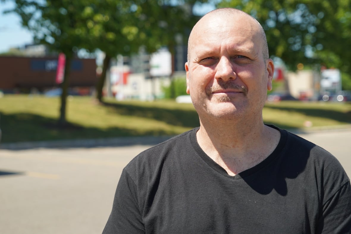 Glenn Garinther photographed in a grocery store parking lot in London.