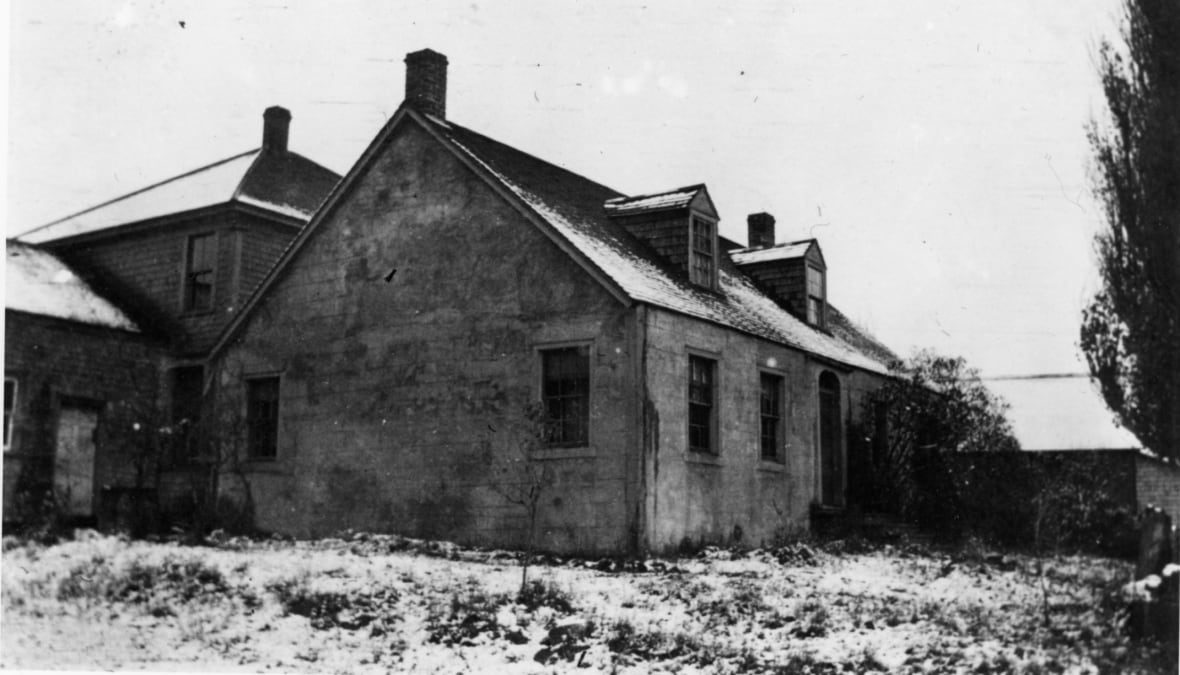 Old black and white photo of a house. 
