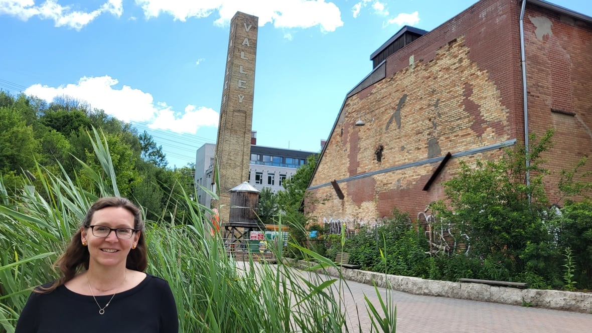 Woman in front of chimney at Evergreen Brick Works