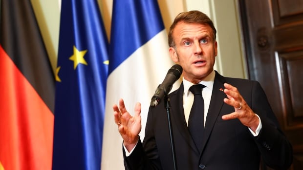 French President Emmanuel Macron talks to media in Berlin, Germany. 