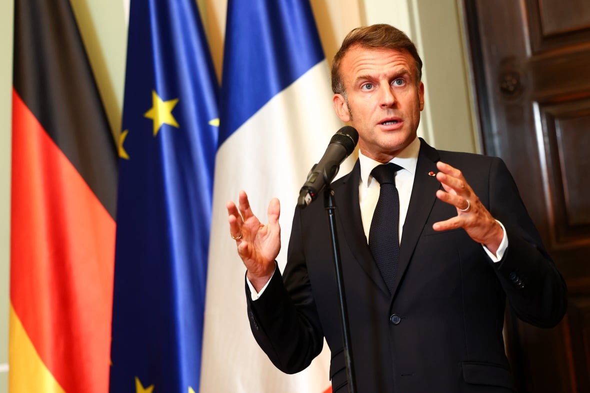 French President Emmanuel Macron talks to media in Berlin, Germany. 