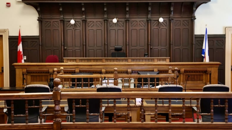 An empty wood-panelled courtroom 