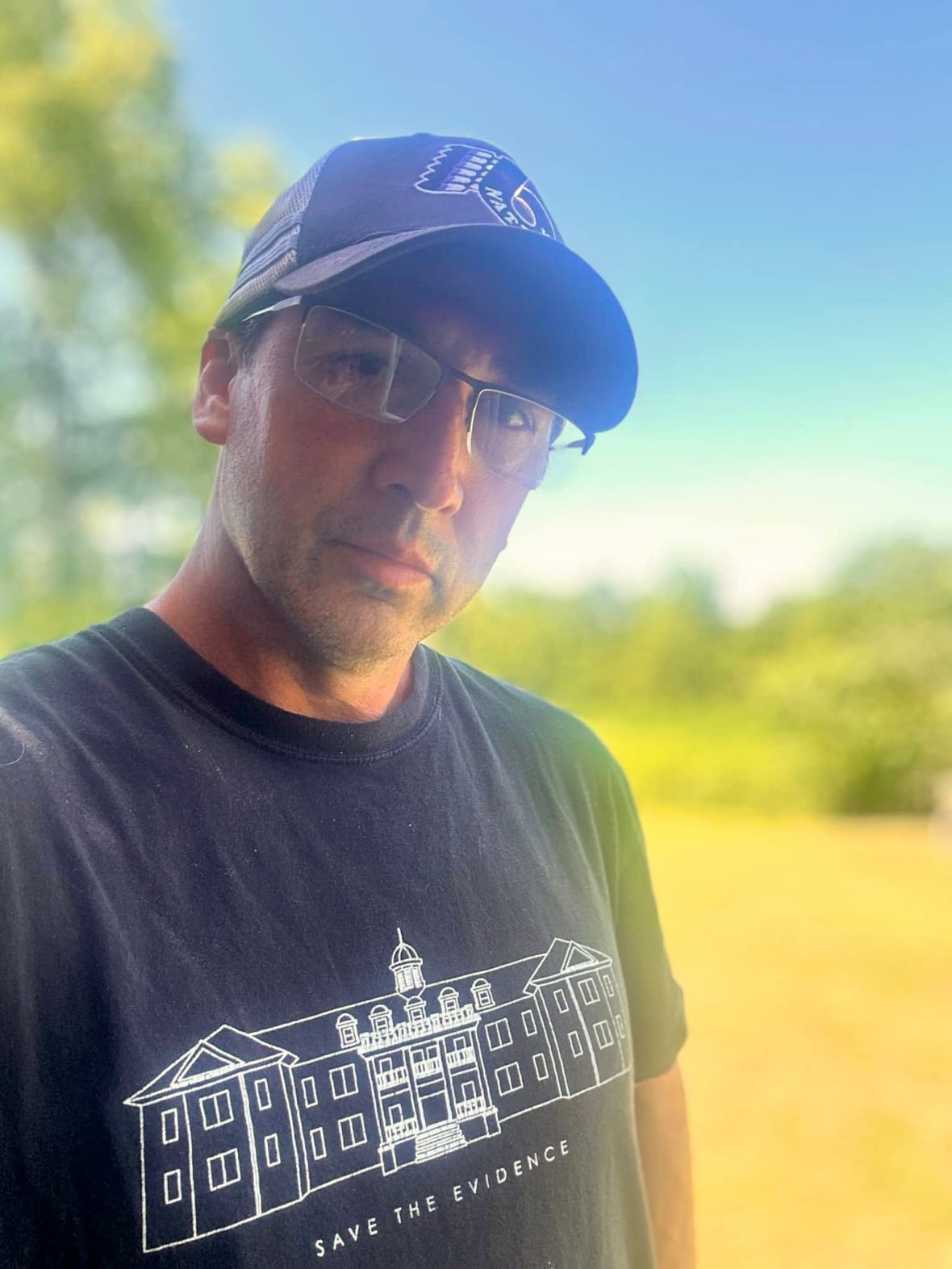 Man wearing 'Save the Evidence' t-shirt.