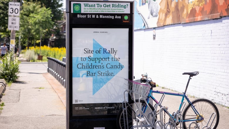 A poster installed near bike stand to mark a historic site. 