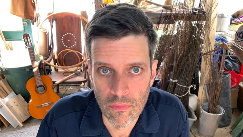 A man looks into a webcam.