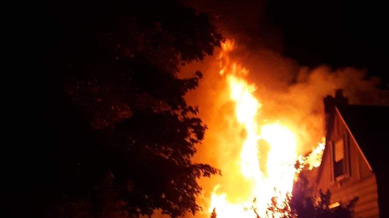 Flames shoot out from a Moy Avenue home in the south Walkerville area of Windsor on July 24, 2025 around 9:30 p.m.