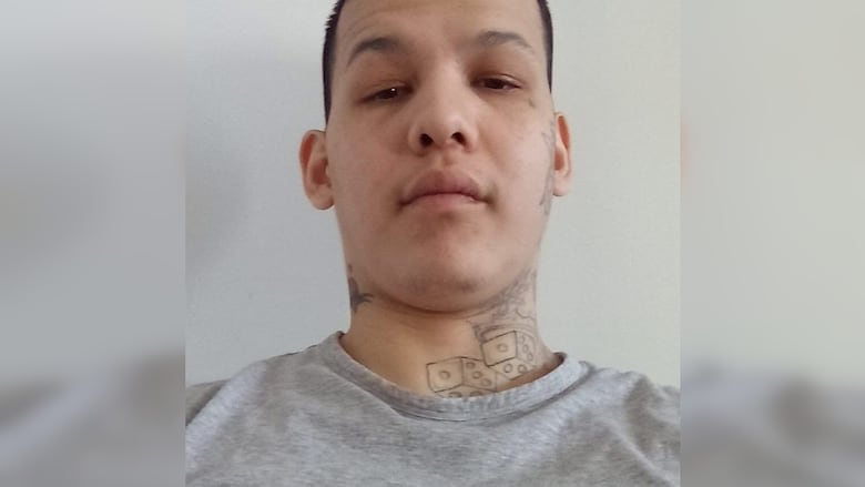 A man's face is seen looking down into the camera lens