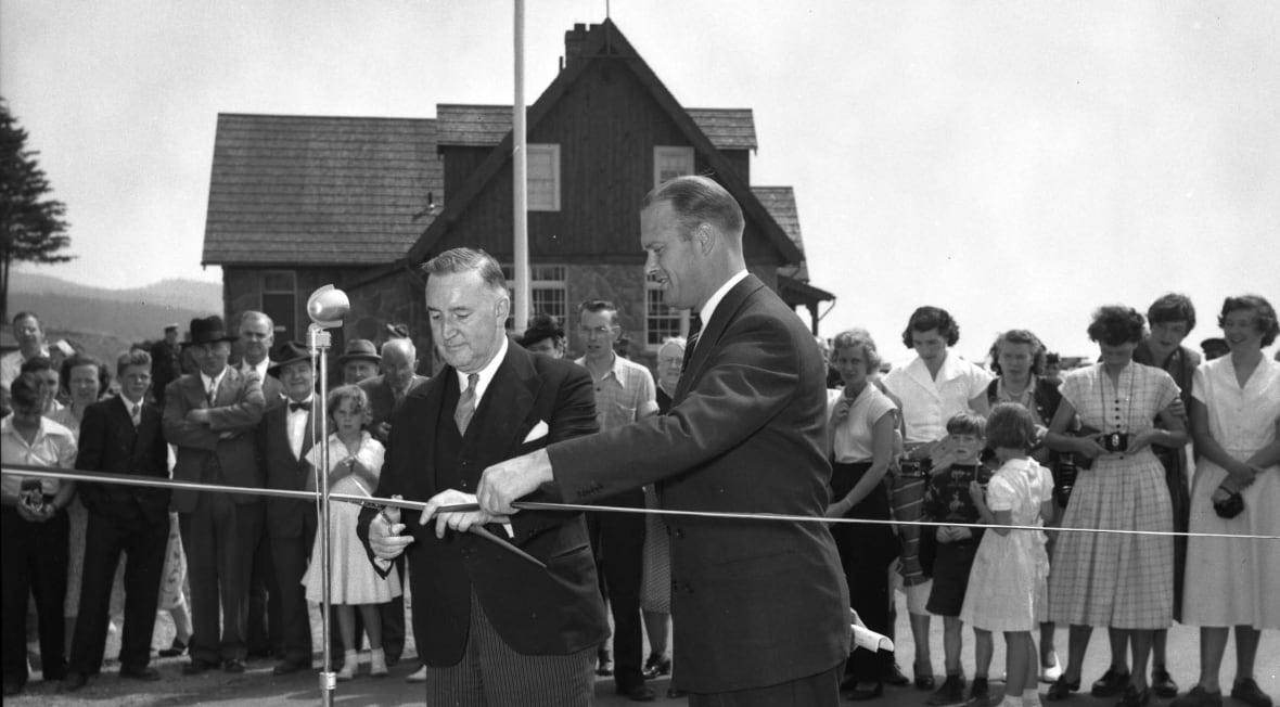 Two men cutting a ribbon