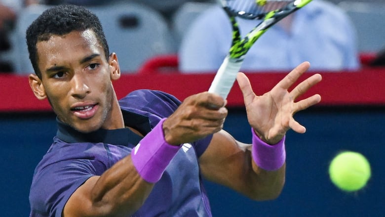A male tennis player hits a shot back to his opponent.