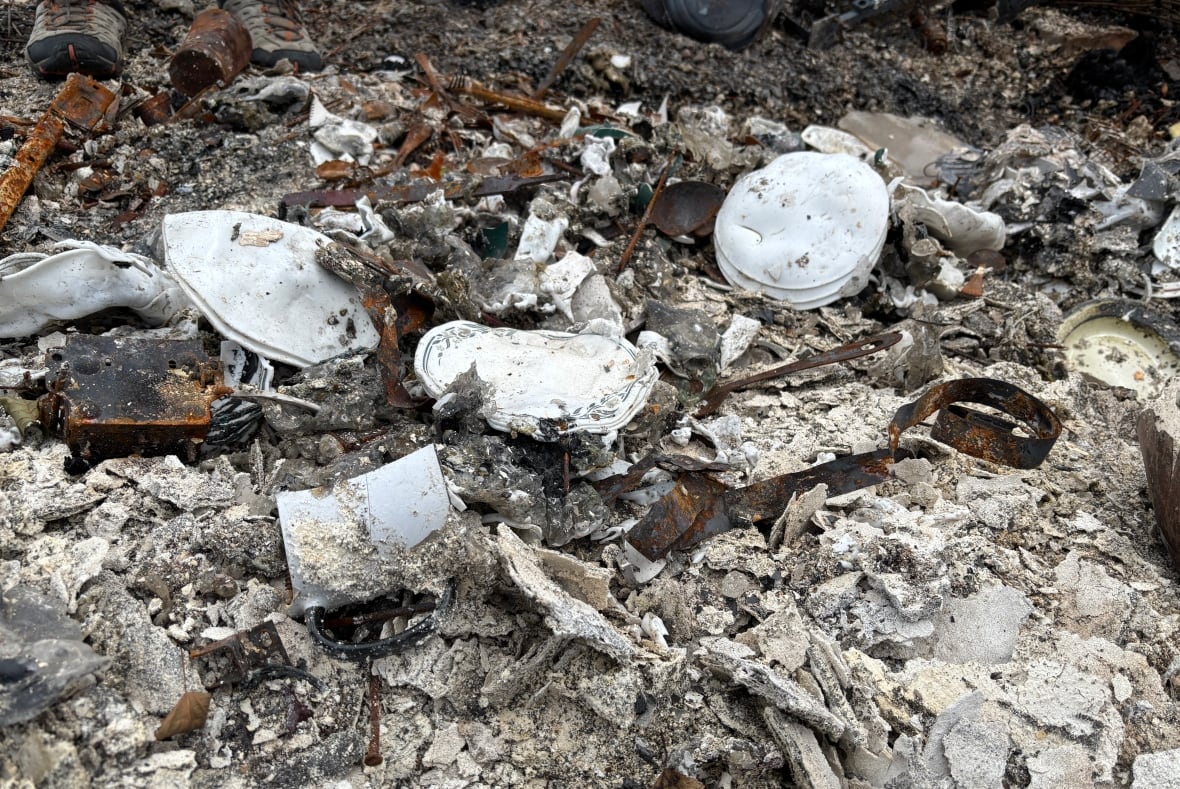 Melted plates lie on rubble and debris.