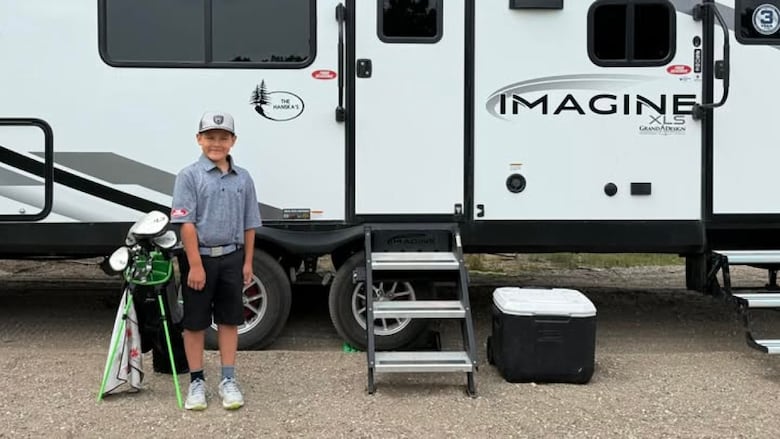 Connor Hanska standing next to his golf clubs before leaving for Northern Ireland.