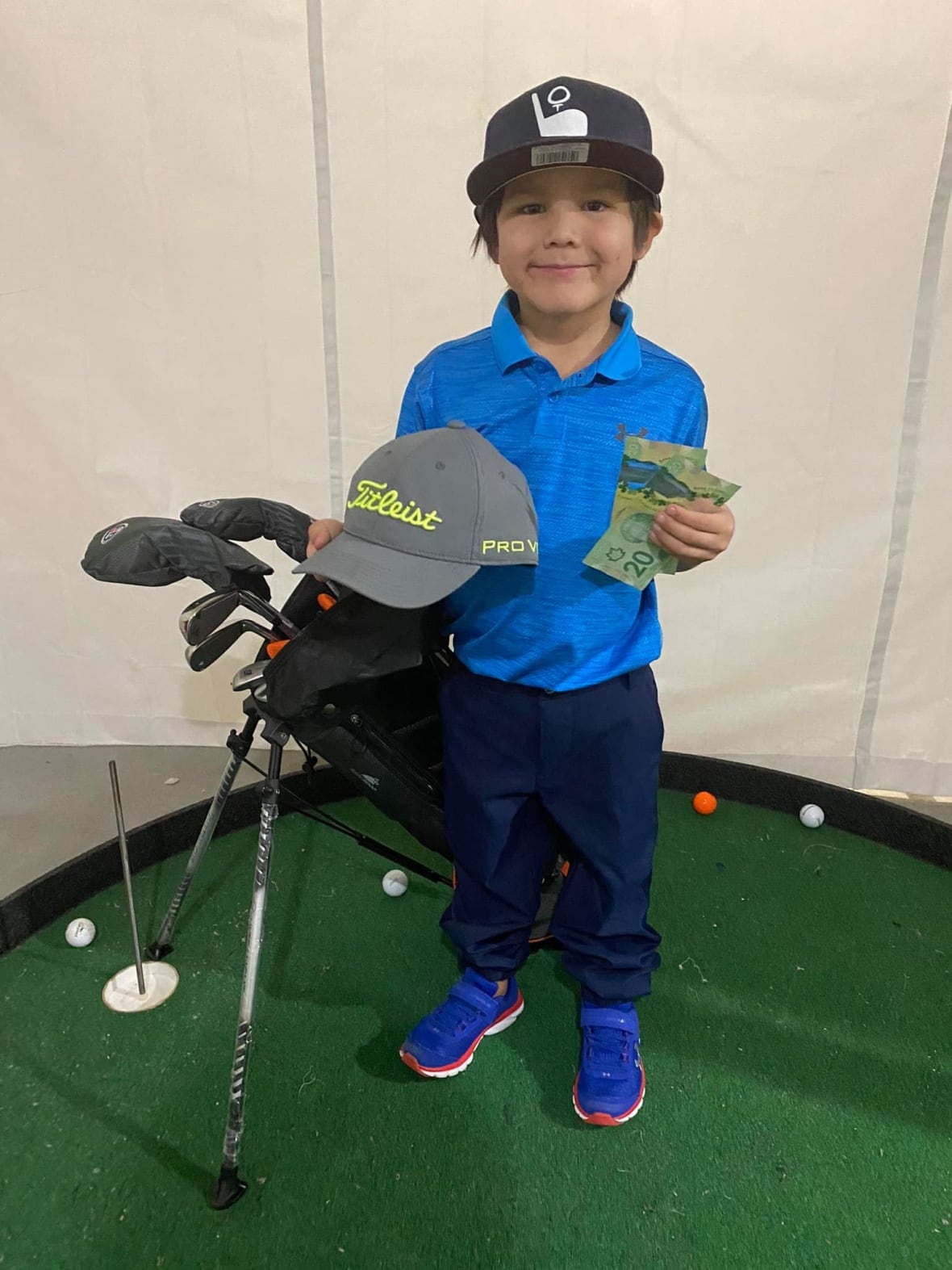 Connor Hanska with a winning prize for a golf tournament.